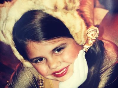 Brooke Markham is posing with her head resting on her hand.